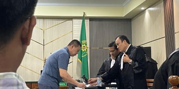PEMBELAAN : Bengawan Kamto sedang berdiskusi dengan tim penasihat hukum terkaiat pembelaaan terdakwa
