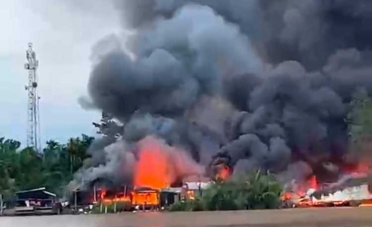 TERBAKAR : Kepulan asap hitam pekat membumbung tinggi saat kebakaran melanda kawasan Pasar Teluk Nilau, Kecamatan Pengabuan (Ist)